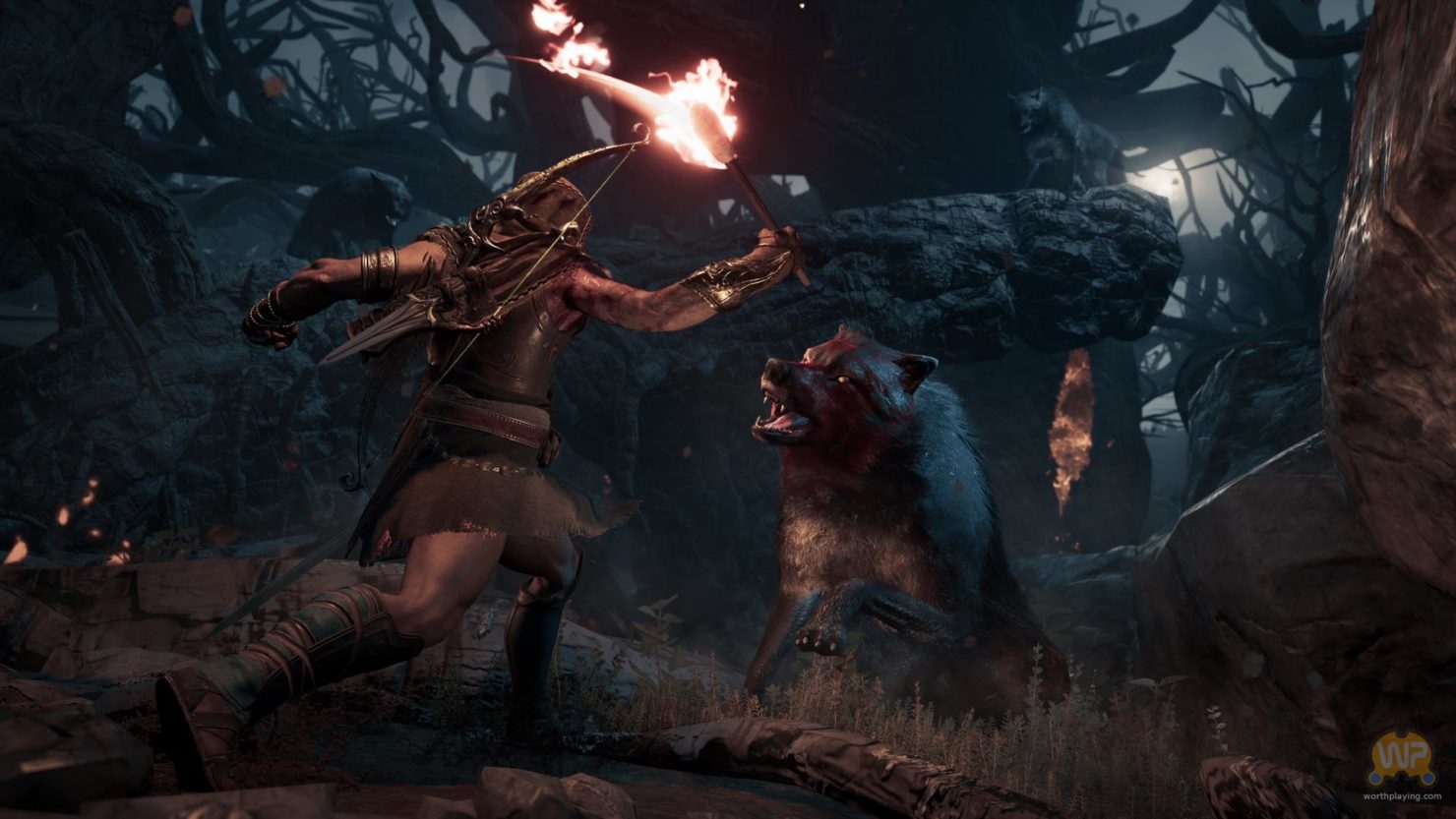 Assassin's Creed Odyssey assassin avec une torche contre loup, en pleine nuit